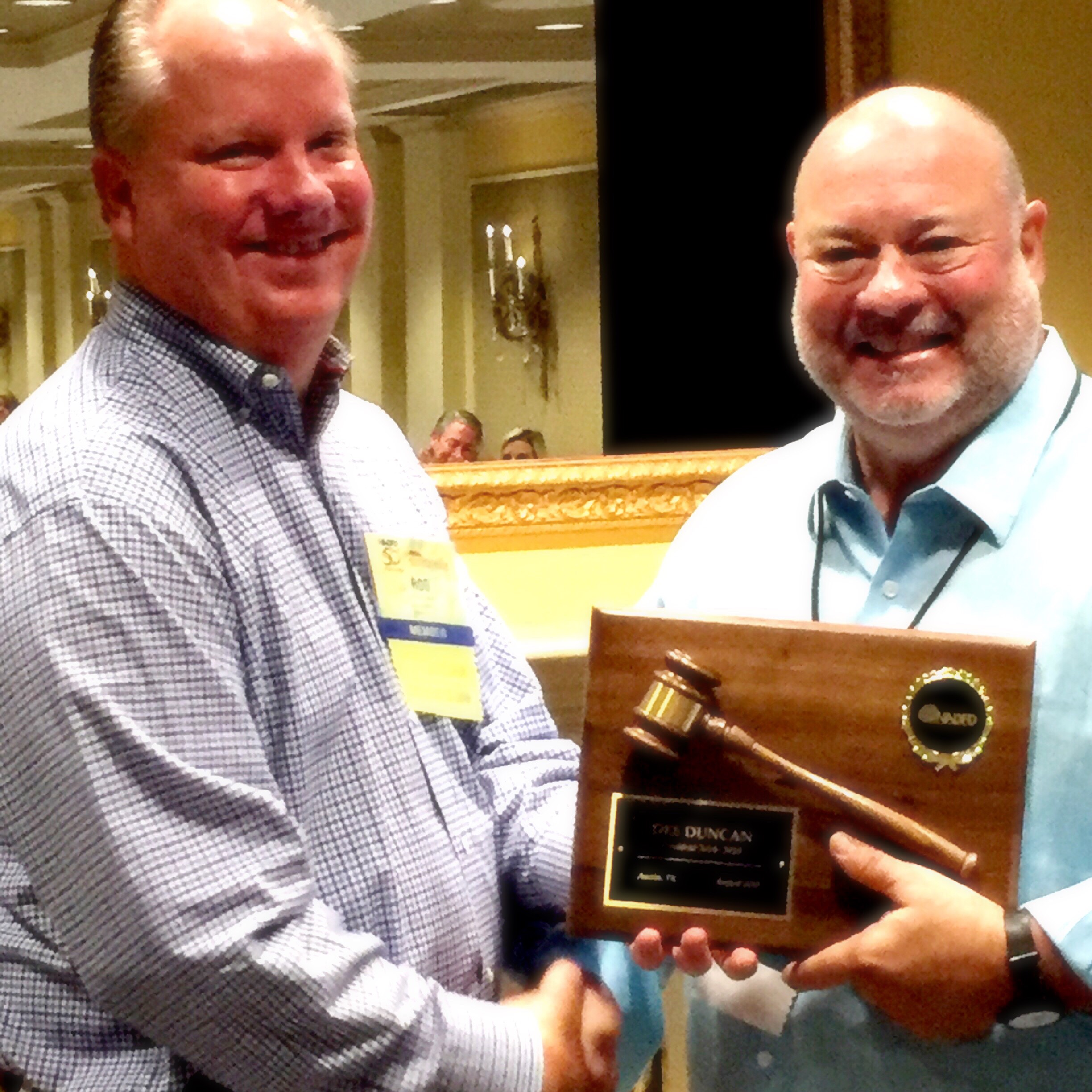 New NADFD President Rob Mayer, left, congratulates past president Dee Duncan