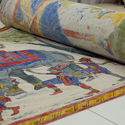 A folkloric hand painted mural for the illiterate population illustrating the history of Siam becoming Thailand. This image of Buddha’s enlightenment’s is the first image on the mural & represents Thailand’s spiritual history.